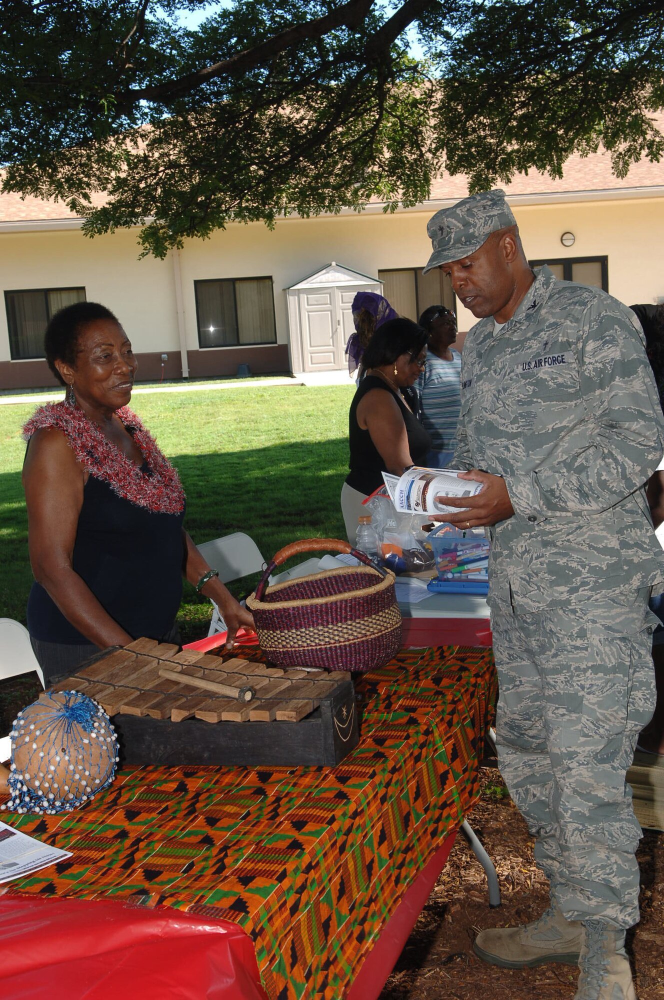 Col. Keith Darlington, Command Chaplain, Hickam Chapel, talks with Deloris Guttman of the African American Diversity Cultural Center Hawaii during a cultural showcase for African Americans in Hawaii on 4 Feb 2011 at the Hickam Community Center on Joint Base Pearl Harbor-Hickam, Hawaii. (U.S. Air Force photo/David D. Underwood, Jr.)