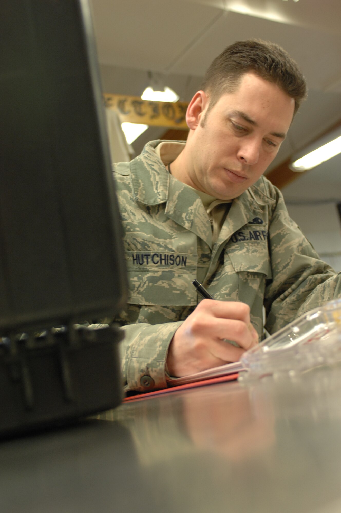 MOUNTAIN HOME AIR FORCE BASE, Idaho -- Staff Sgt. Jason Hutchinson, 389th Aircraft Maintenance Unit support technician, writes down data after synchronizing the e-tools laptop computer program. Sergeant Hutchinson is only one of 18 support and supply professionals who helps ensure the wing’s aircraft and equipment are fully functional. (U.S. Air Force photo by 1st Lt. Neil Samson)