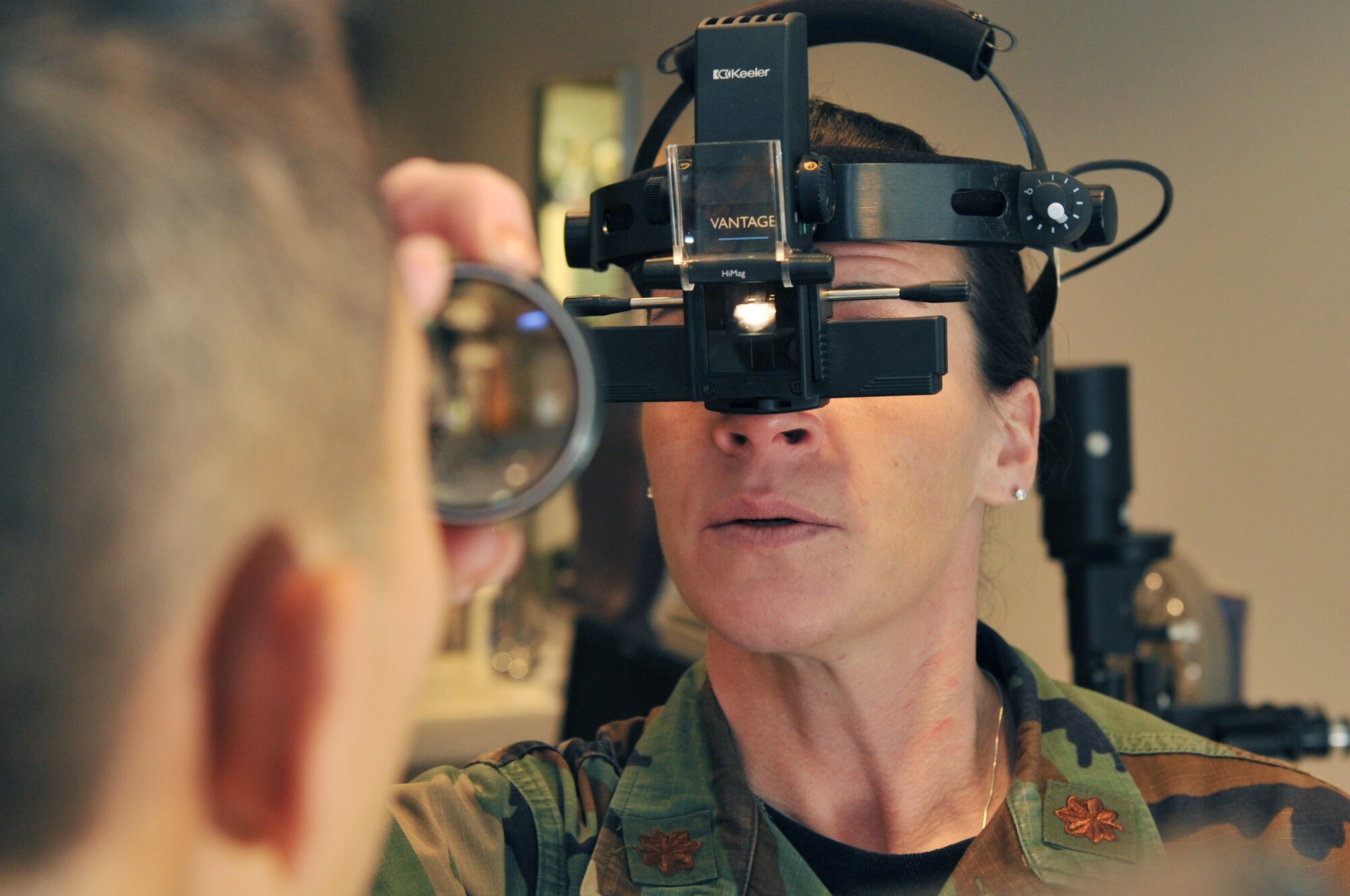 Maj. Patricia Hoogeveen, 19th Aerospace Medical Squadron optometry flight commander, checks the retinas of a patient at Little Rock Air Force Base, Ark., Feb. 8, 2011. Part of a routine eye exam includes checking the retinas. (U.S. Air Force photo by Airman 1st Class Rusty Frank)