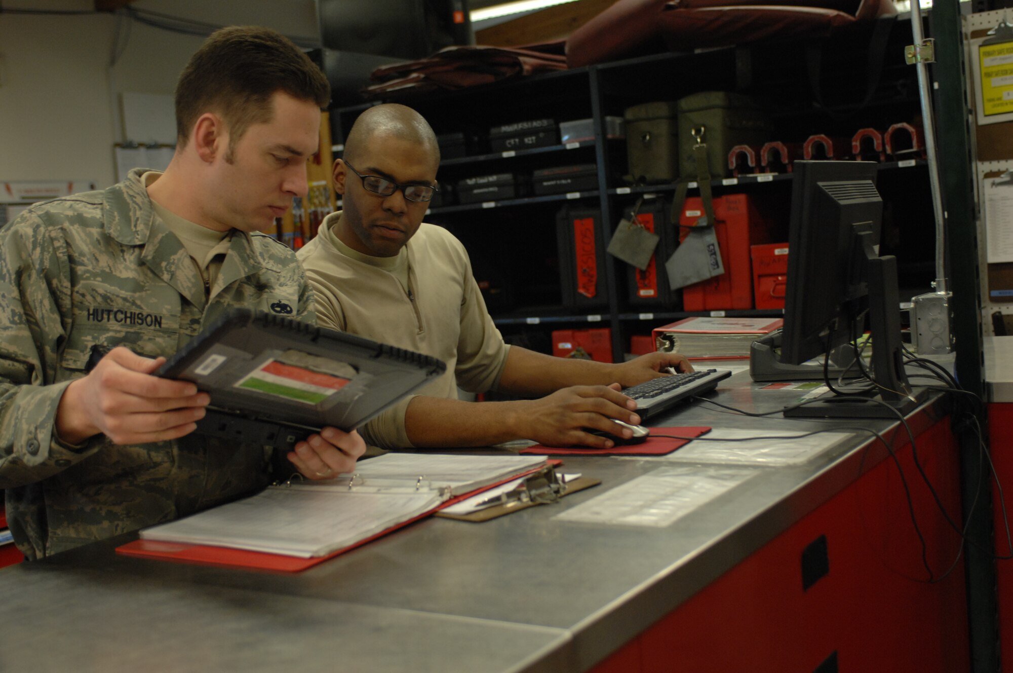 MOUNTAIN HOME AIR FORCE BASE, Idaho -- Staff Sgt. Jason Hutchinson, 389th Aircraft Maintenance Unit support technician, shares his data inputs from an e-tools laptop computer program with Senior Airman Cameron Evans, 389th Aircraft Maintenance Unit support technician, who will then input it on a support section computer. The support section is charged with maintaining a library of technical data and specialized tools in the squadron. (U.S. Air Force photo by 1st Lt. Neil Samson)