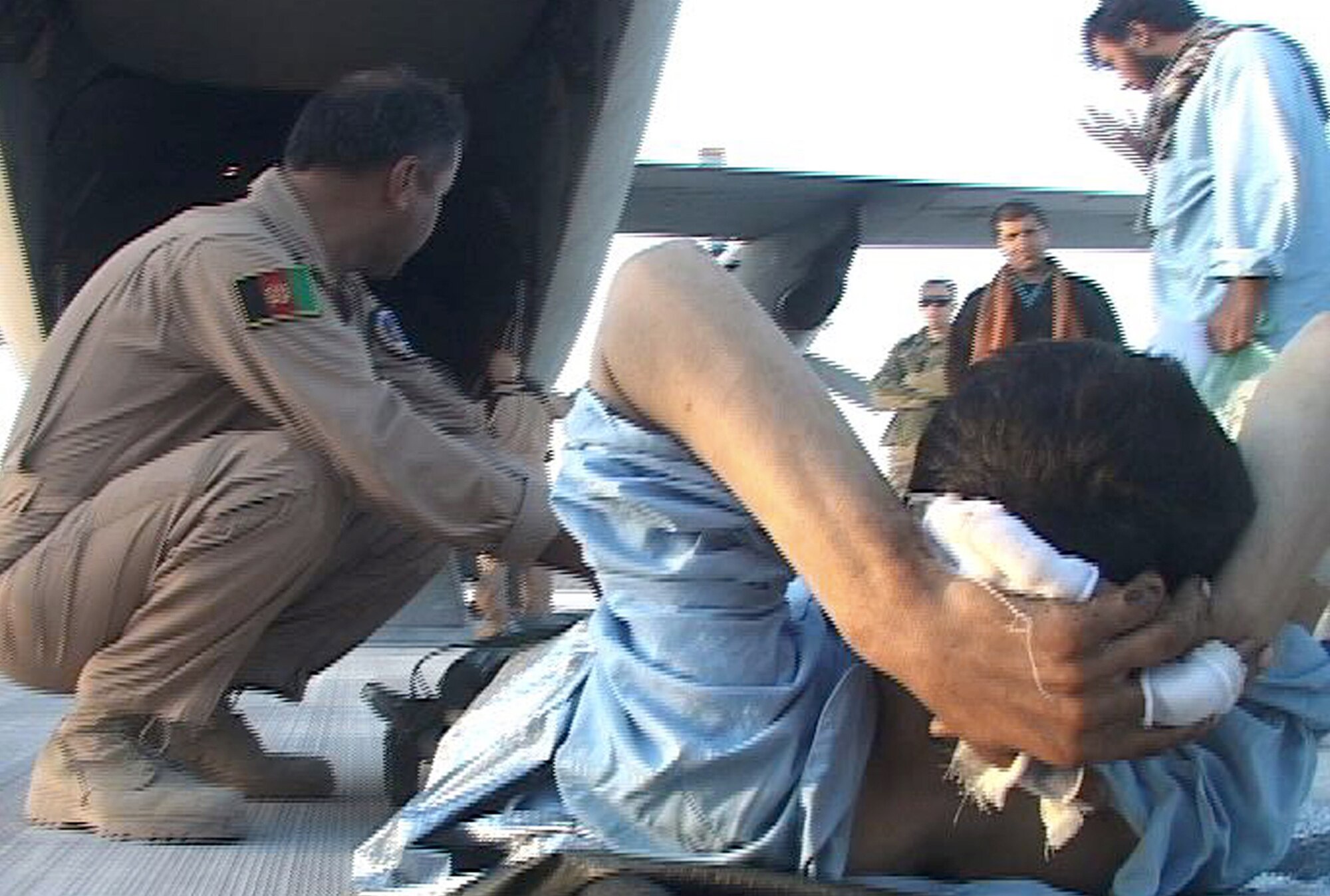 Afghan airmen prepare to load an injured Afghanistan National Security Forces soldier onto a C-27 Spartan aircraft Jan. 26, 2011, for a medical evacuation flight to Kabul, from Kandahar Airfield, Afghanistan. (U.S. Navy photo/Petty Officer 2nd Class Vladimir Potapenko) 