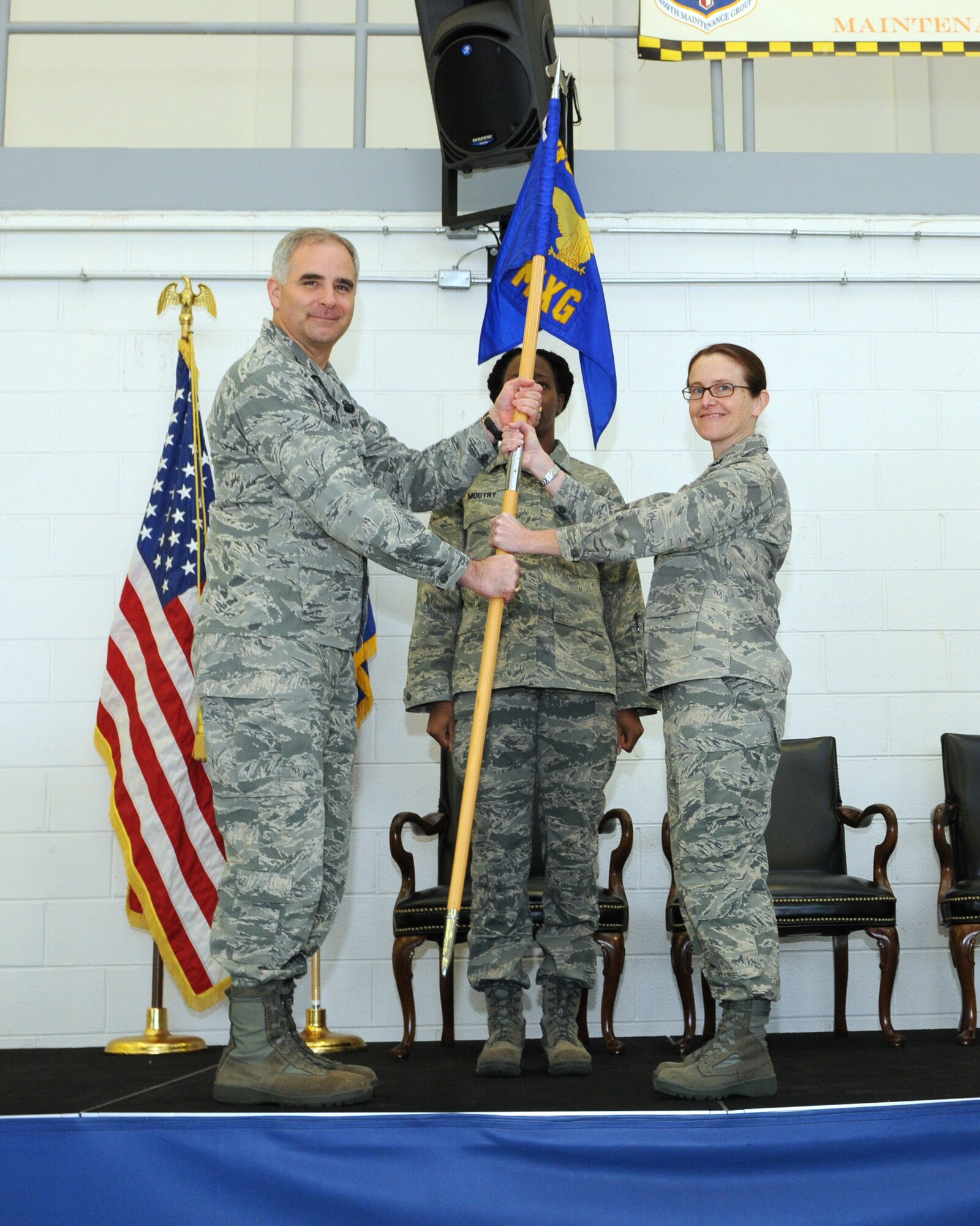 JOINT BASE ANDREWS, Md. -- Col. James M. Allman (left), 459th Air Refueling Wing commander, passes the guidon to Col. Maureen G. Banavige in a change of command ceremony here Feb. 6. Colonel Banavige assumes command of the 459th Maintenance Group after serving previously as an Individual Mobilization Augmentee to the Chief, Logistics Operations Division, Directorate of Logistics, Air Mobility Command, Scott Air Force Base, Ill. (U.S. Air Force photo/Tech. Sgt. Steve Lewis)