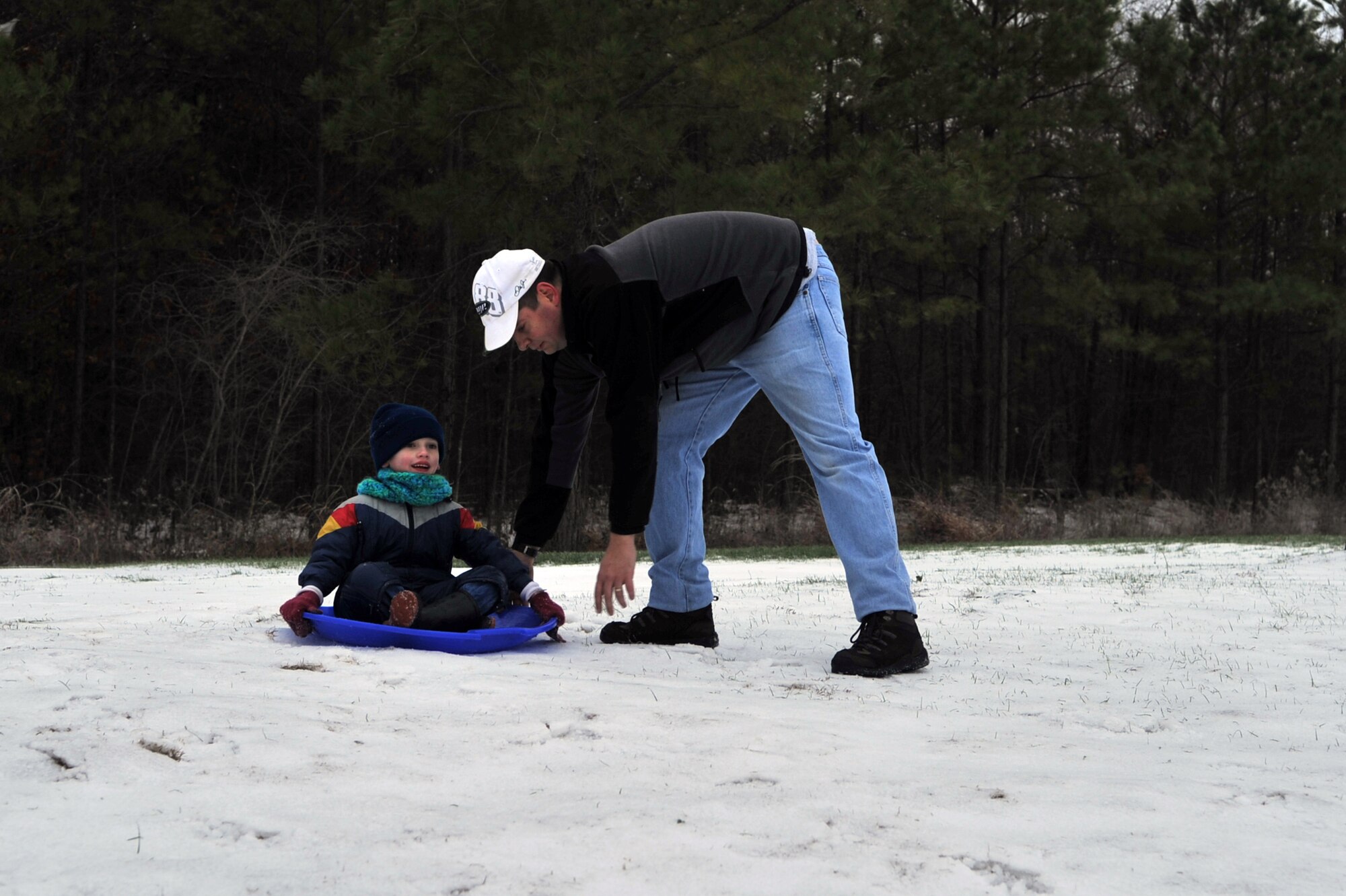 Tech. Sgt. William Ostrom, 2nd Logistics Readiness Squadron, prepares to push his 5-year-old son, Case, down a hill in their back yard on Barksdale Air Force Base, La., Feb. 4. Due to snow and hazardous driving conditions in North Western Louisiana, many schools were closed for the day. (U.S. Air Force photo/Airman 1st Class Micaiah Anthony)(Released)
