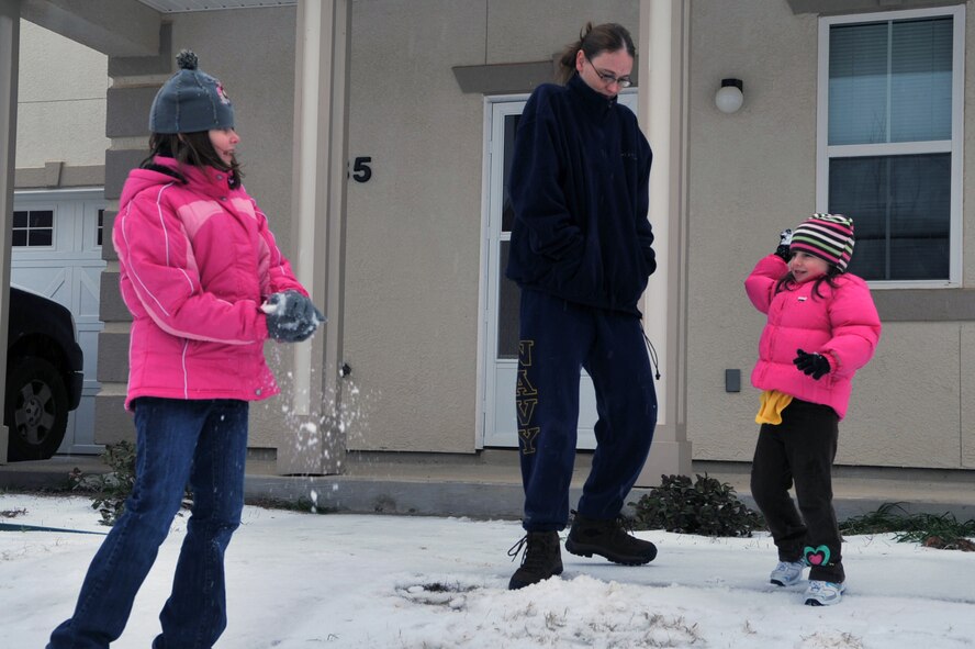 U.S. Navy Petty Officer 2nd Class Jennifer Counha, assigned to the Naval Mobile Construction Battalion 28, watches her daughters Rebekkah, 10, (left) and Jacquelyn, 5, (right) play in the snow in front of their house on Barksdale Air Force Base La., Feb. 4. The Counha's enjoyed their snow day by having snowball fights and making snow angels. (U.S. Air Force photo/Airman 1st Class Micaiah Anthony)(Released)
