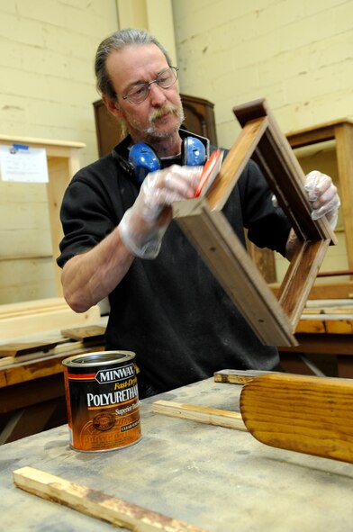 Mike Jarrett, 2nd Force Support Squadron wood crafts center manager, stains a shadow box and certificate holder Feb. 8 at Barksdale Air Force Base, La. Mr. Jarrett builds retirement and going-away gifts, trophy cases, recognition boards, podiums, conference tables and much more. "I can pretty much build anything a customer needs as long as it is made of wood," he said. Anyone who needs assistance with a project can receive help from Mr. Jarrett. The wood crafts center also has classes to teach others how to use the wood-working tools. For more information, call 456-3409. (U.S. Air Force photo/Staff Sgt. John Gordinier)(released)
