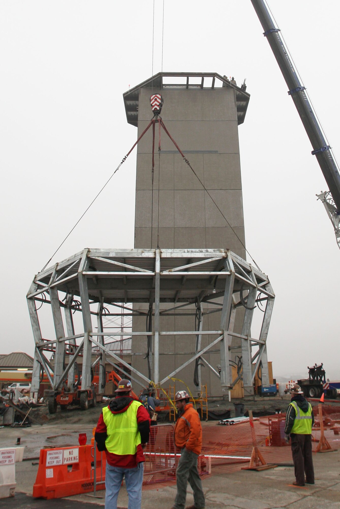 The frame of the new control tower cab is carefully lifted as construction crews place it onto the top of the tower structure here Feb 1. (U.S. Air Force Photo/Don Peek)