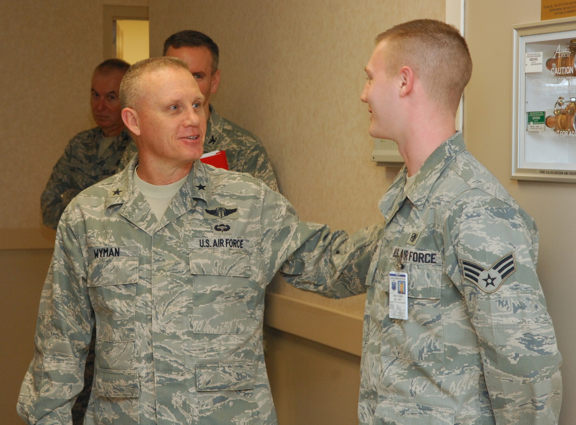 LANGLEY AIR FORCE BASE, Va. – Brig. Gen. Daniel Wyman, Air Combat Command surgeon general, congratulates Senior Airman Bryan Ross, 633d Dental Squadron dental lab technician, Feb. 3, for his outstanding work at the USAF Hospital Langley Dental Clinic General Wyman toured the newly renovated hospital to examine operations and acknowledge outstanding performers within the 633d Medical Group.  (U.S. Air Force photo/Airman 1st Class Elizeu) (Released)