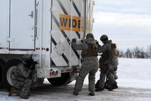 MINOT AIR FORCE BASE, N.D. -- Members of the 791st Missile Security Forces Squadron, open the back door of a payload transporter as part of a training exercise during Prairie Sentry 11-2 here Feb. 2.  Exercises like this give Air Force Global Strike Command Airmen the opportunity to maintain their combat operation skills. (U.S. Air Force photo/Senior Airman Michael J. Veloz)