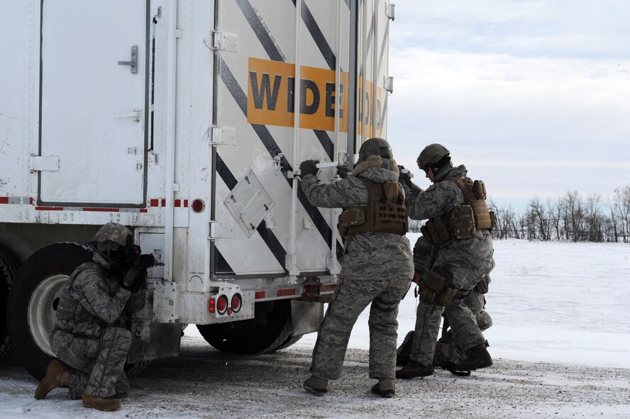 MINOT AIR FORCE BASE, N.D. -- Members of the 791st Missile Security Forces Squadron, open the back door of a payload transporter as part of a training exercise during Prairie Sentry 11-2 here Feb. 2.  Exercises like this give Air Force Global Strike Command Airmen the opportunity to maintain their combat operation skills. (U.S. Air Force photo/Senior Airman Michael J. Veloz)