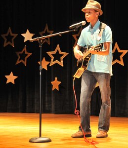 Jerimiah King, son of Drnetra and Adrian King, performs Moonlight during the annual 2011 “You Got Talent” Family and Teen Talent contest Feb. 5 at the air base theater. Jerimiah was the award winner for the solo act ages 13-18 and will be participating for an AMC level award.