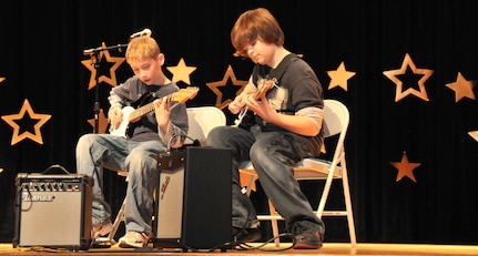 Christopher Montrose and Corey Leydig strum an instrumental of Fade to Black by Metallica Feb. 5 during the annual “You Got Talent” Family and Teen Talent contest at the air base theater. Christopher is the son of Master Sgt. Mark Montrose and Corey is the son of Master Sgt. Donny Leydig.