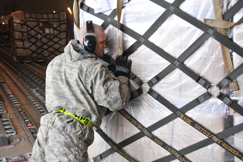 Staff Sgt Richard Maines, Air Transportation craftsman from the 437th Aerial Port Squadron, loads a pallet containing 12 Low-Cost, Low-Velocity parachutes onto a contracted 747. The parachutes are used to deliver critical supplies to troops in isolated locations worldwide. (U.S. Air Force photo by Airman Jared Trimarchi). 