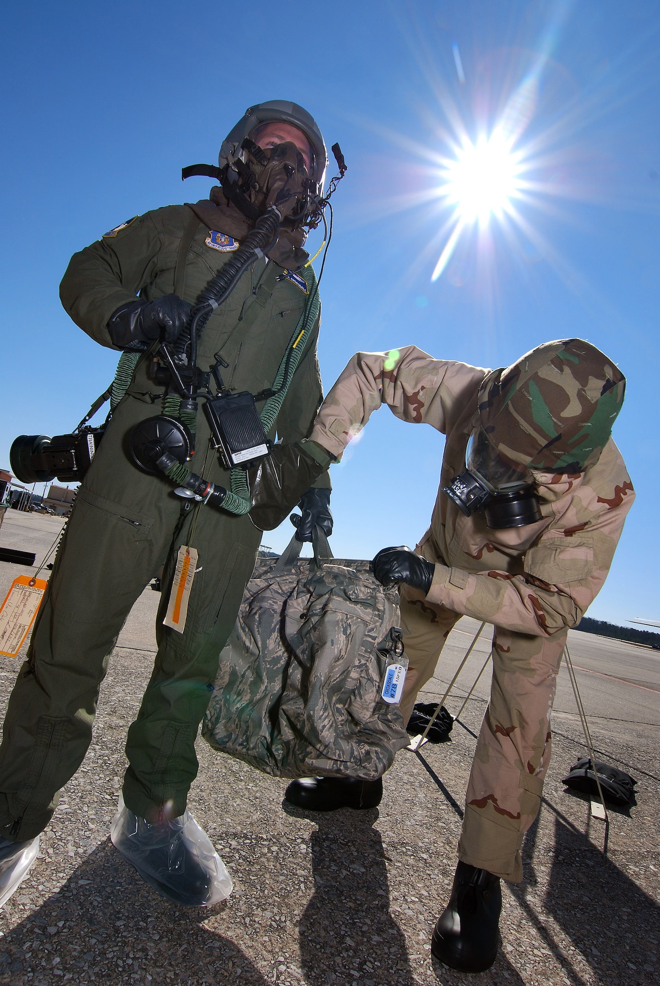 Tech Sgt. Lance Wilson, an Aircrew Flight Equipment technician, uses a simulated charcoal pad to pat down 1st Lt. Seth King, a pilot with the 700th Airlift Squadron, during decontamination training, 6 Feb.  A lucky couple of airmen get to dress out and go through the stations as the rest of the class observes for the refamiliarization training.  The training takes them from start to finish through an Air Force decontamination line and provides good insight as to what to they will experience in the process.  (U.S.  Air Force photo/ Brad Fallin)
