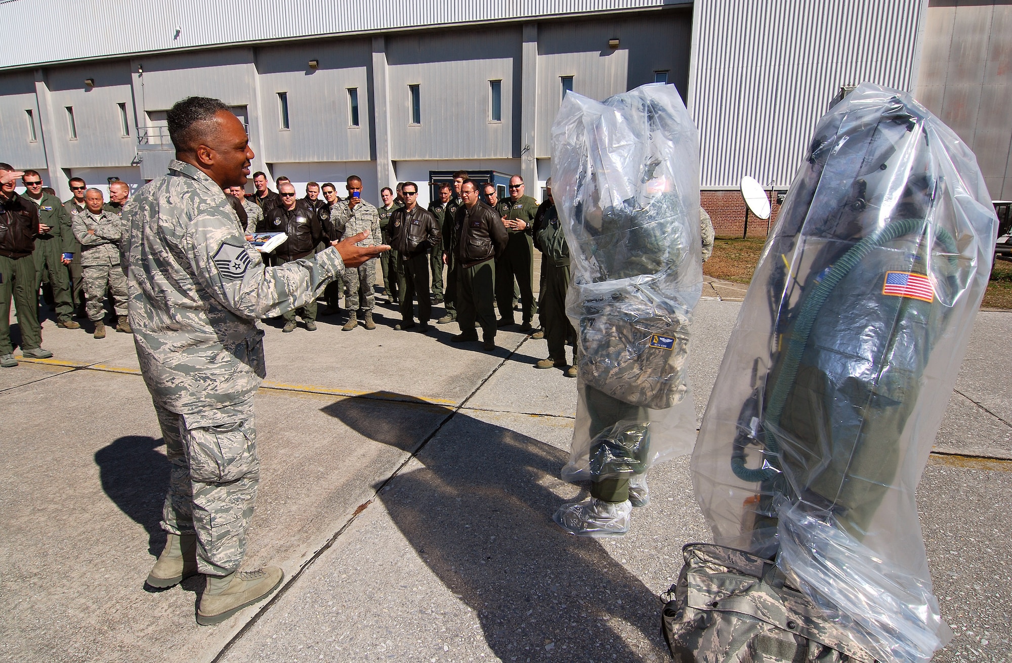 Master Sgt. Mike Varnado, Aircrew Flight Equipment Training NCOIC, briefs 94th Airlift Wing aircrew members at the starting point for aircrew decontamination training, 6 Feb.  A lucky couple of airmen get to dress out and go through the stations as the rest of the class observes for the refamiliarization training.  The training takes them from start to finish through an Air Force decontamination line and provides good insight as to what to they will experience in the process.  (U.S.  Air Force photo/ Brad Fallin)