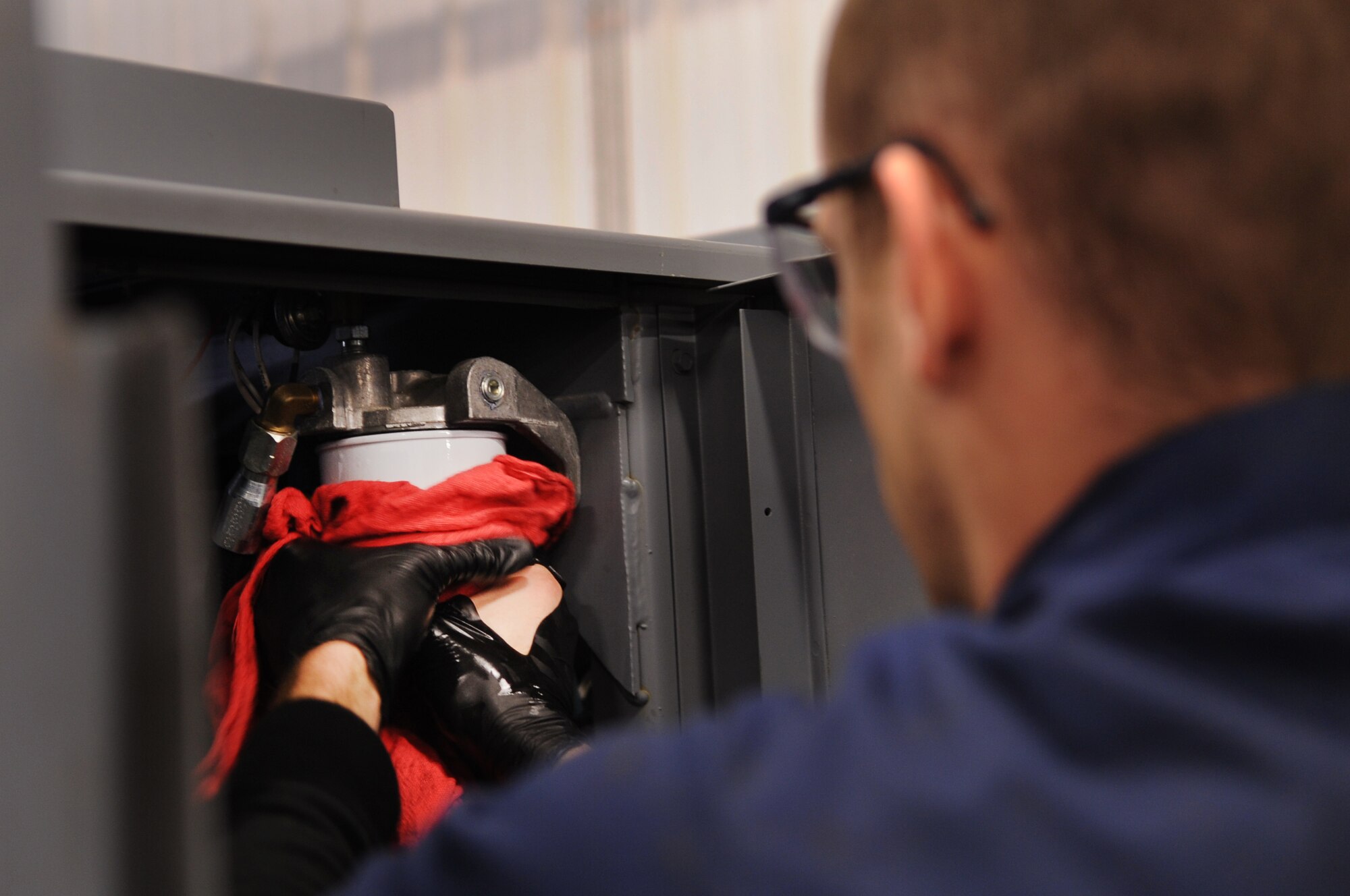 MOODY AIR FORCE BASE, Ga. -- Airman 1st Class Gregory Lyon, 23rd Equipment Maintenance Squadron air ground equipment flight apprentice, twists a fuel filter on a generator set Feb. 8. This was during a Phase II inspection to prepare the generator for use. (U.S. Air Force photo/Airman 1st Class Douglas Ellis)(RELEASED)
