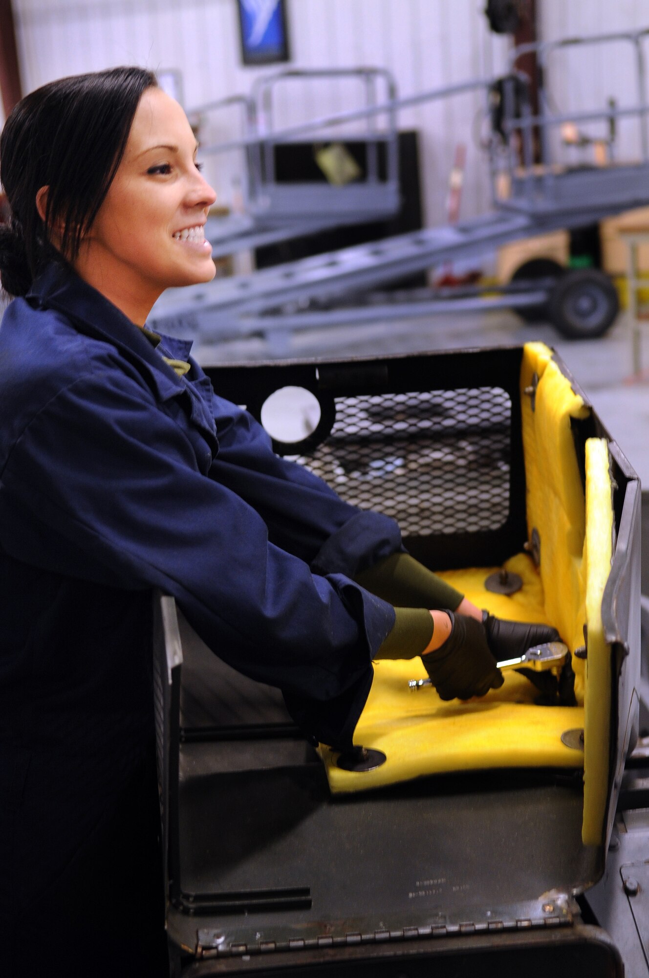 MOODY AIR FORCE BASE, Ga. -- Senior Airman Megan Noah, 23rd Equipment Maintenance Squadron air ground equipment flight journeyman, works on a MJ-1B bomb lift during an inspection Feb. 8. Airman Noah was installing new hood insulation to the bomb lift. (U.S. Air Force photo/Airman 1st Class Douglas Ellis)(RELEASED)
