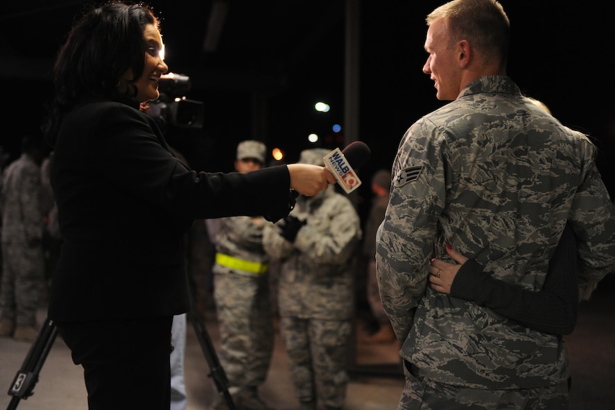 MOODY AIR FORCE BASE, Ga.-- —Christian Jennings, local news broadcaster, interviews Senior Airman Jody Winnett, 723rd Aircraft Maintenance Squadron HH-60G Pave Hawk instrument and flight control journeyman, as 70 members from Moody return from a deployment Feb. 8.  Local media came to cover the return of the 723rd AMXS as they came back from a four-month deployment to Joint Base Balad, Iraq. (U.S. Air Force photo/Airman 1st Class Benjamin Wiseman)(RELEASED)
