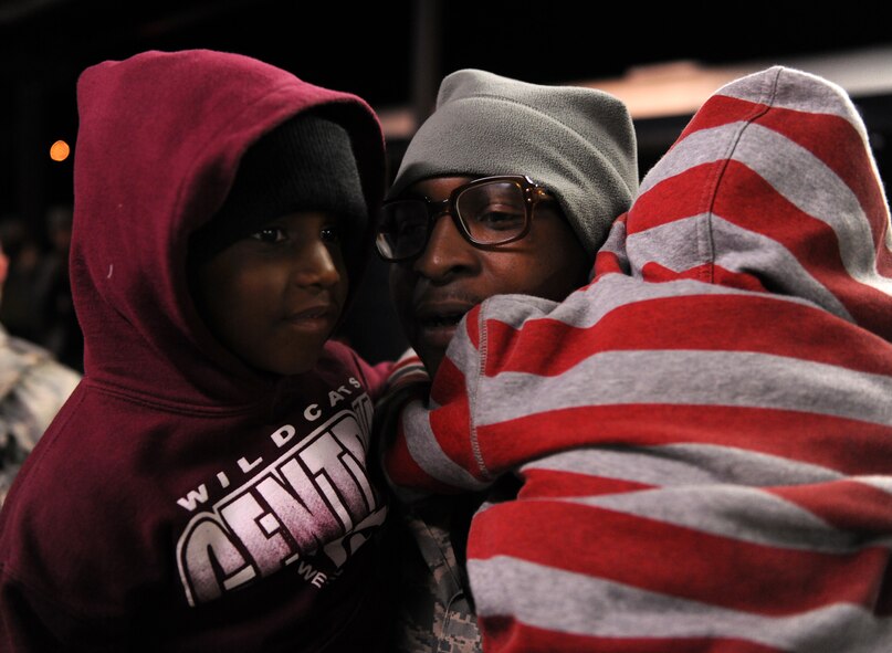 MOODY AIR FORCE BASE, Ga.-- Staff Sgt. Marcus Knight, 723rd Aircraft Maintenance Squadron weapons load crew chief, hugs his sons, Nicholas and Marcus, after returning from a deployment Feb. 8. Sergeant Knight was reunited with his family after being deployed to Joint Base Balad, Iraq, for four months. (U.S. Air Force photo/Airman 1st Class Benjamin Wiseman)(RELEASED)