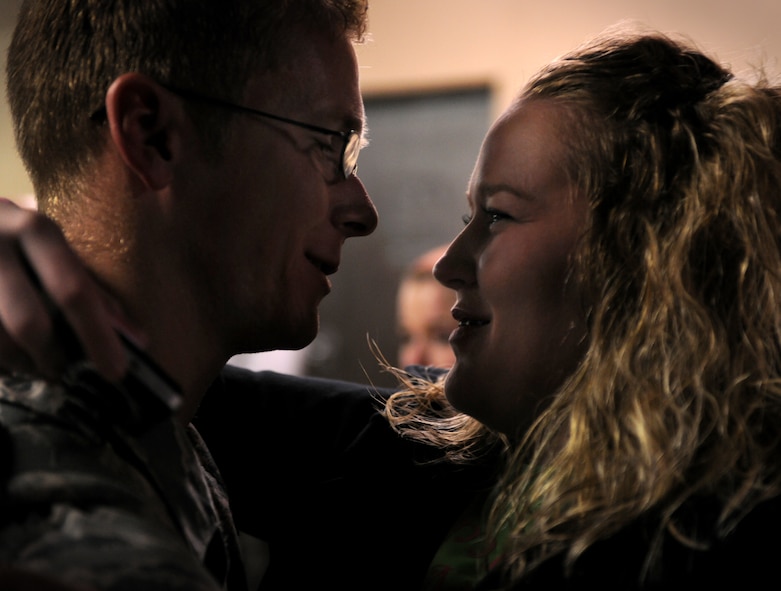 MOODY AIR FORCE BASE, Ga.-- Staff Sgt. Alexander Alexander, 23rd Equipment Maintenance Squadron aircraft structure technician, embraces his wife, Kimber, after returning from a deployment Feb. 8. Several spouses and family members came to support their Airmen as 70 members from Moody returned home from deployment. (U.S. Air Force photo/Airman 1st Class Benjamin Wiseman)(RELEASED)