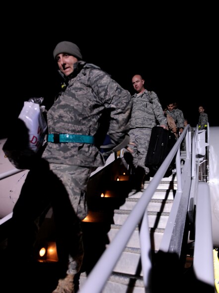 MOODY AIR FORCE BASE, Ga.-- Moody personnel exit a commercial aircraft after returning from a four-month deployment to Southwest Asia Feb. 8. After unloading the aircraft, members were transported to the 723rd Aircraft Maintenance Squadron building where their friends and families were waiting with anticipation. (U.S. Air Force photo/Airman 1st Class Benjamin Wiseman)(RELEASED)