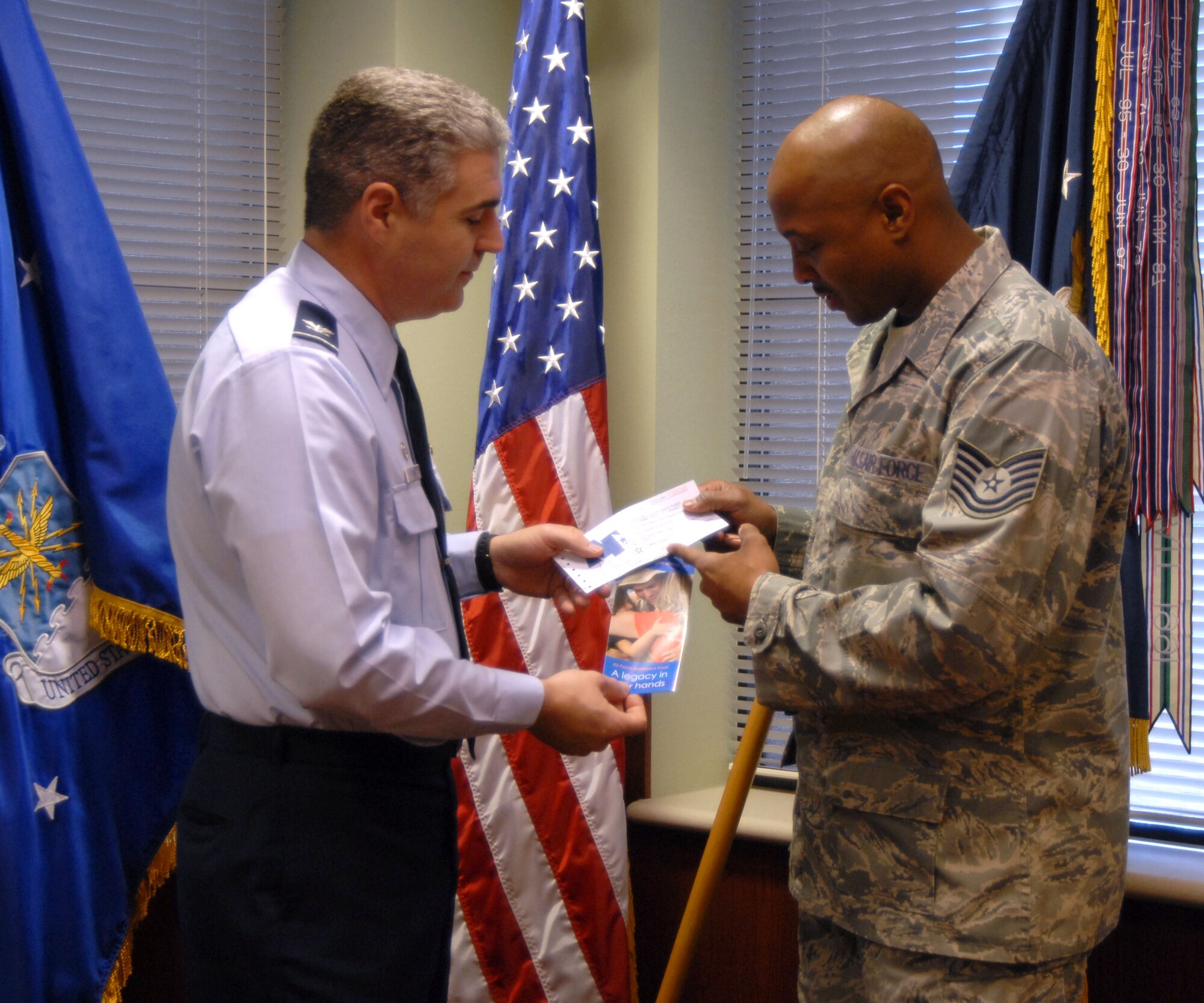 GOODFELLOW AIR FORCE BASE, Texas--  Col. Thomas Geary, 17th Training Wing Commander, and Technical Sgt. Tommy Nixon, Executive Assistant to the 17th Training Wing to the Command Chief, discuss the merits of donating to the  Air Force Assistance Fund. The annual campaign raises money exclusively to help military members and their families;  Goodfellow's goal this year is to raise more than $62,000. (U.S. Air Force photo/Airman 1st Class Jessica D. Keith) 