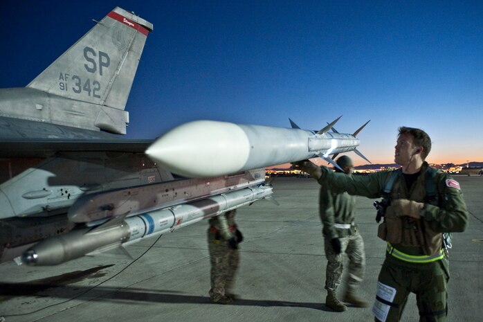 NELLIS AIR FORCE BASE, Nev.-- Capt. Brian Morrissey, 480th Fighter Squadron pilot, from Spangdahlem Air Base Germany, conducts a pre-flight check on a F-16 Fighting Falcon before a night training mission during Red Flag 11-2  Feb. 2. Red Flag is a realistic combat training exercise involving the air forces of the United States and its allies. (U.S. Air Force photo by Tech. Sgt. Michael R. Holzworth)