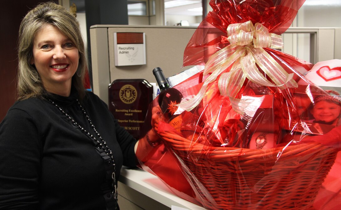 Mary Lyman, 932nd Airlift Wing Recruiting, was named the civilian employee Volunteer of the Year for 2010.  Mrs. Lyman was recognized for her many hours supporting unit morale and welfare programs.  She stands next to a Valentine's Day gift basket that will be raffled off at the February drill weekend to help raise funds. Mrs. Lyman gathered the items and put the basket together.  (U.S. Air Force photo/Tech. Sgt. Dan Oliver) 