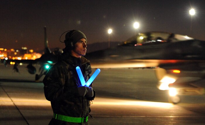 NELLIS AIR FORCE BASE, Nev.-- Senior Airman Corey Glezen, 480th Aircraft Maintenance Squadron crew chief, prepares to taxi out a F-16 Fighting Falcon during Red Flag 11-2 Feb. 2. Red Flag is a realistic combat training exercise involving the air forces of the United States and its allies. The exercise is conducted on the 15,000-square-mile Nevada Test and Training Range, north of Las Vegas. (U.S. Air Force photo by Airman 1st Class Matthew Lancaster)