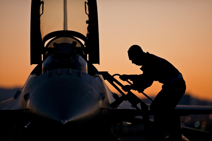 NELLIS AIR FORCE BASE, Nev.-- Senior Airman Thomas McGuire, 480th Aircraft Maintenance Squadron crew chief, from Spangdahlem Air Base Germany, conducts pre-flight checks on a F-16 Fighting Falcon during Red Flag 11-2 Feb. 2. Red Flag is a realistic combat training exercise involving the air forces of the United States and its allies. (U.S. Air Force photo by Tech. Sgt. Michael R. Holzworth)