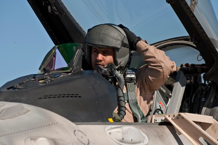 NELLIS AIR FORCE BASE, Nev.--United Arab Emirates, Lt. Saeed Alahbabi, Saheen 3 Squadron pilot,  puts on his flight helmet in a F-16E Desert Falcon on the flight line during Red Flag 11-2 Feb. 2. Red Flag is a realistic combat training exercise involving the air forces of the United States and its allies. The exercise is hosted north of Las Vegas on the Nevada Test and Training Range.(U.S. Air Force photo by Tech. Sgt. Michael R. Holzworth)