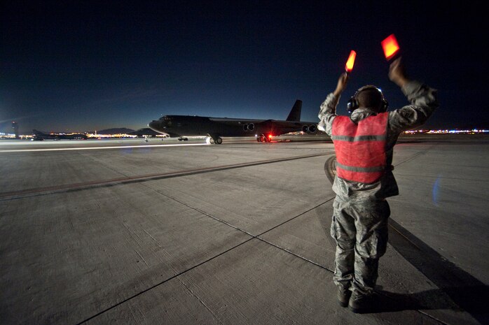 NELLIS AIR FORCE BASE, Nev. --Airman 1st Class David Parson, 2nd Aircraft Maintenance Squadron crew chief, from Barksdale Air Force Base La., marshals a B-52 Stratofortress out for a night training mission during Red Flag 11-2 Jan. 26. Red Flag is a realistic combat training exercise involving the air forces of the United States and its allies. (U.S. Air Force photo by Tech. Sgt. Michael R. Holzworth)