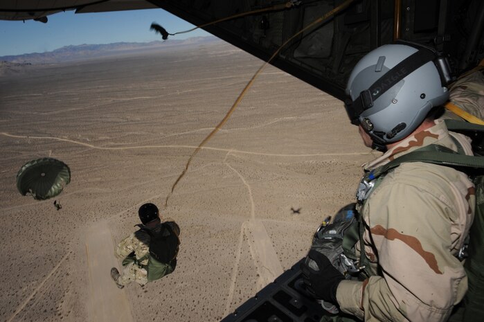 NELLIS AIR FORCE BASE, Nev.--Pararescuemen from the 58th Rescue Squadron, exit a C-130 Hercules during a training mission Jan. 26 over the Nevada Test and Training Range during Red Flag 11-2. Air Force Special Operations Command's pararescuemen, also known as PJs, are the only Department of Defense specialty specifically trained and equipped to conduct conventional or unconventional rescue operations.(U.S. Air Force photo by Master Sgt. Kevin J. Gruenwald)