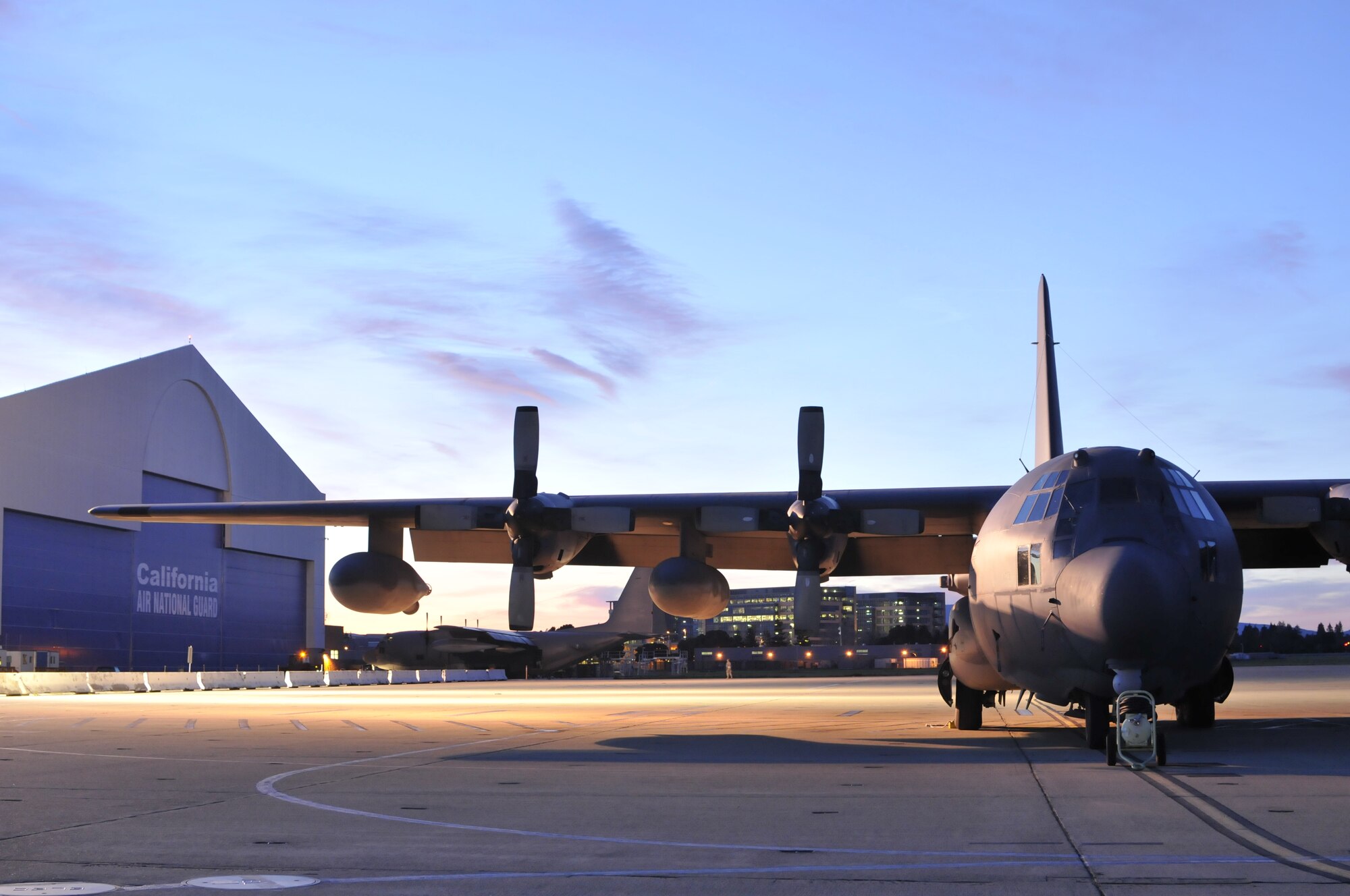 A California Air National Guard MC-130P Combat Shadow aircraft is parked on the flightline during sunrise as members of the 129th Rescue Wing arrive for monthly drill at Moffett Federal Airfield, Calif., Feb. 6, 2011.  (Air National Guard photo by Staff Sgt. Kim E. Ramirez/Released)