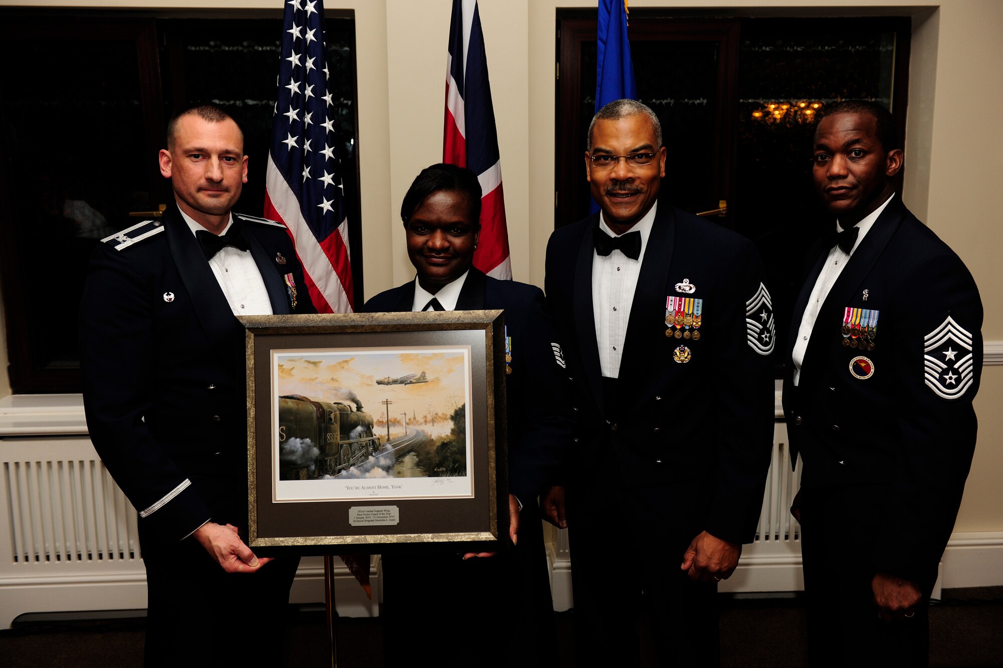 RAF ALCONBURY, United Kingdom - Tech. Sgt. Deneisha Jones accepts the Base Honor Guard of the Year Award during the 501st Combat Support Wing Annual Awards Ceremony Feb. 4 at RAF Alconbury. Sergeant Jones is assigned to the 423rd Civil Engineer Squadron. (U.S. Air Force photo by Tech. Sgt. John Barton)