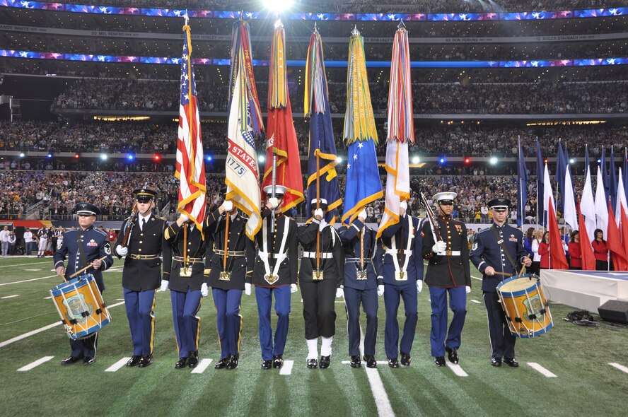 An Armed Forces Color Guard from Washington, D.C., along with two drummers
from The U.S. Air Force Band march into position on the field for the National Anthem during Super Bowl XLV at Cowboys Stadium in Arlington, Texas on Sunday, February 6. Members of the color guard are from the ceremonial honor guard units in the National Capital Region that perform at official functions at the White House, Pentagon and Arlington National Cemetery. (U.S. Air Force photo/SSgt Christopher Bolen).
