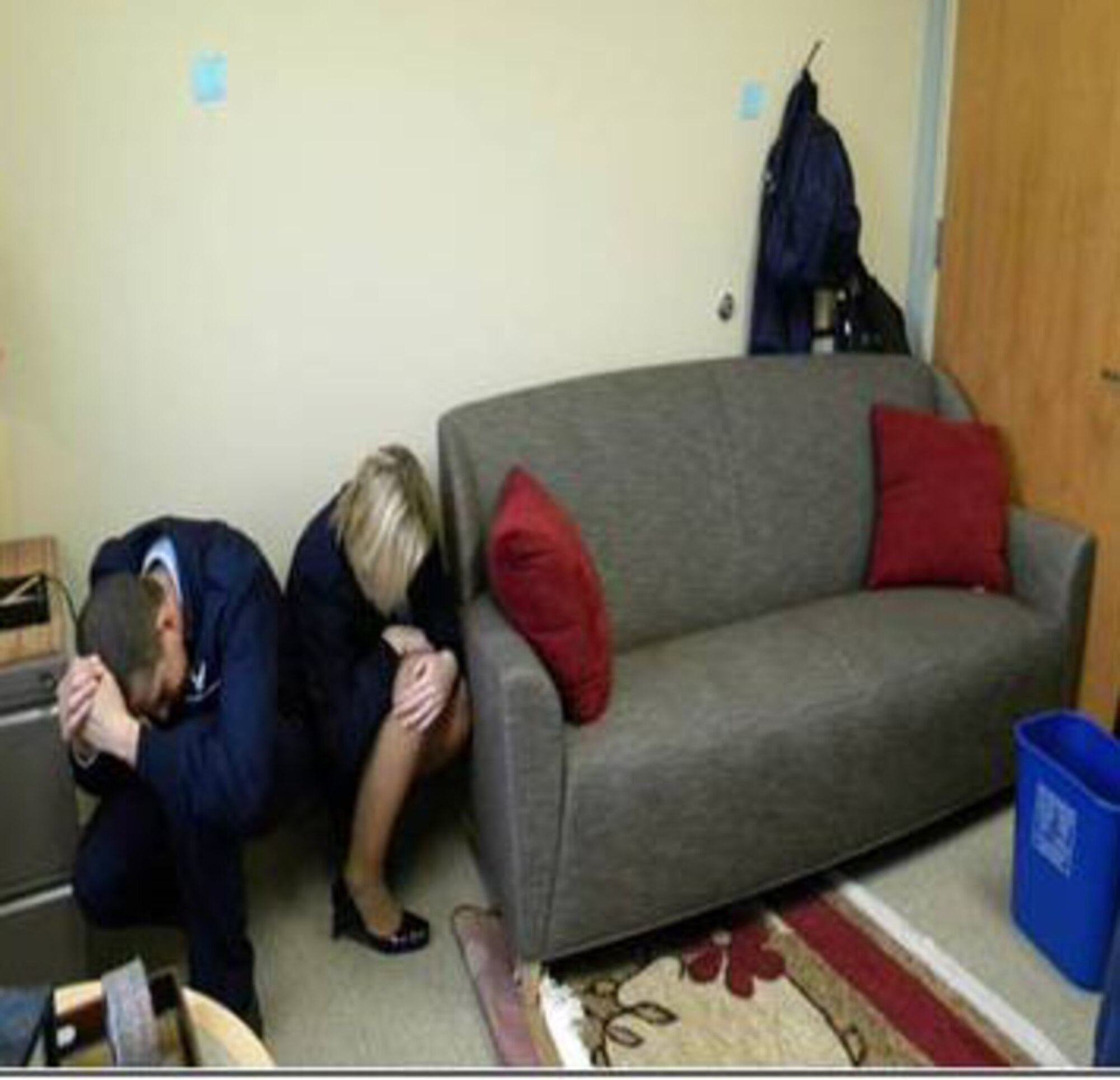 GOODFELLOW AIR FORCE BASE, Texas-- Two Airmen simulate taking cover to protect themselves during an active shooter exercise. (courtesy illustration) 