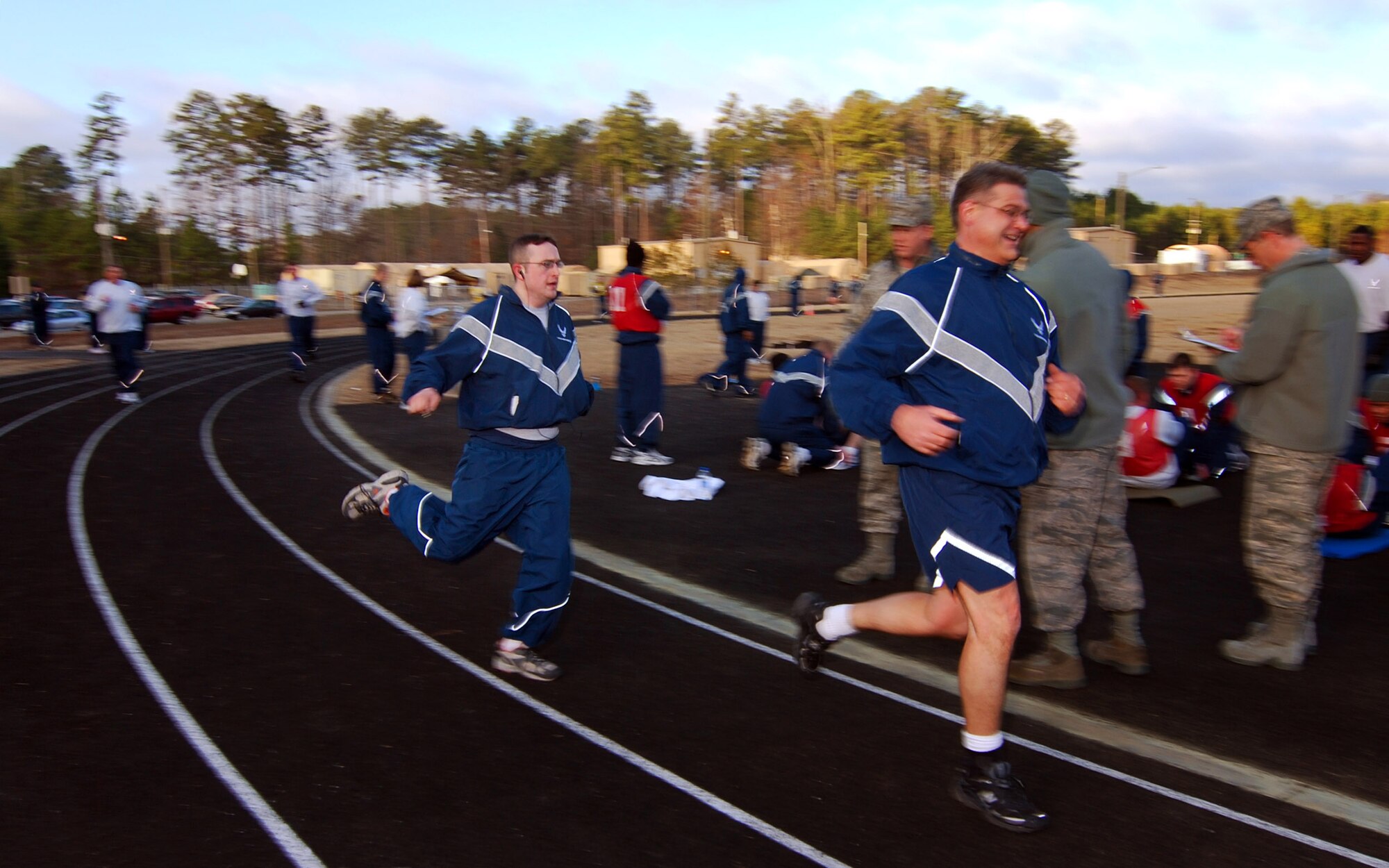 Staff Sgt. Jordan Cote and Senior Master Sgt. Kenneth Cook both complete the mile and a half portion of their bi-annual Air Force fitness test at the new base track, 6 Feb.  The fitness test was recently revised to be administered twice a year along with some adjustments in the minimum standards.  The February Unit Training Assembly was the perfect time to test many 94th Airlift Wing members to see if they are able to meet or exceed the standards.  (U.S. Air Force photo/ Brad Fallin)