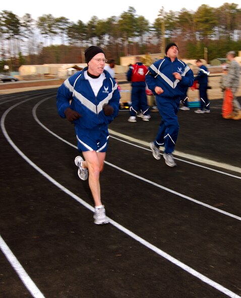 Chief Master Sgt. Steve Hogan and Staff Sgt. Ben Miliken both with 94th Maintenance Squadron run their mile and a half portion of the bi-annual Air Force fitness test at the new base track, 6 Feb.  The fitness test was recently revised to be administered twice a year along with some adjustments in the minimum standards.  The February Unit Training Assembly was the perfect time to test many of the 94th Airlift Wing members to see if they are able to meet or exceed the standards.  (U.S. Air Force photo/ Brad Fallin)