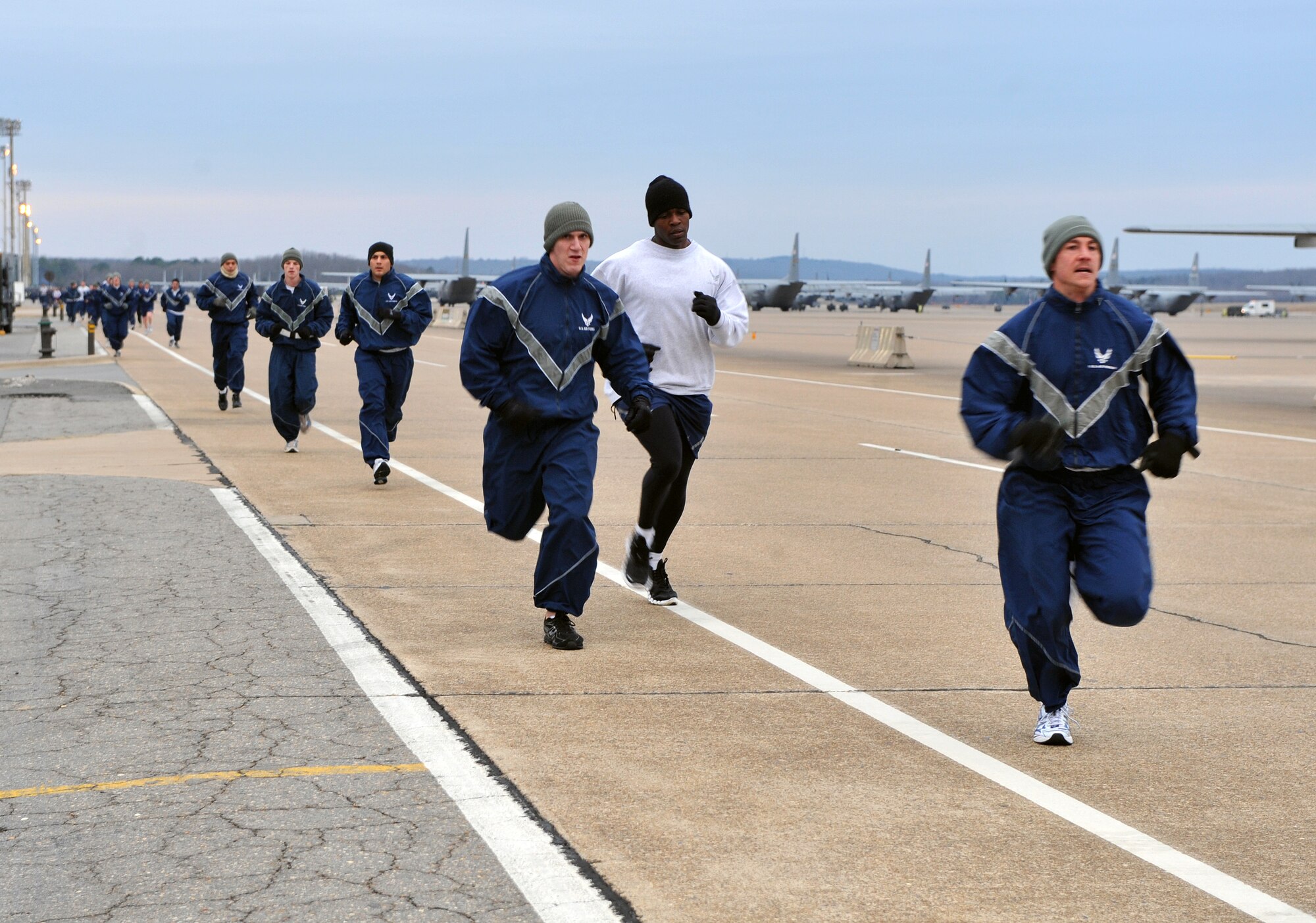Team Little Rock personnel run along Flightline Road Feb. 4, 2011, during the 19th Airlift Wing fun run at Little Rock Air Force Base, Ark. A fun run provides base personnel a chance to get together and start their day as a team, giving each member a morale boost. (U.S. Air Force photo by Senior Airman Gul Crockett)