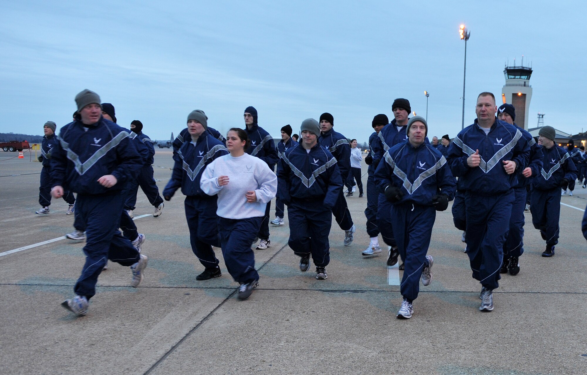 Team Little Rock personnel run along Flightline Road Feb. 4, 2011, during the 19th Airlift Wing fun run at Little Rock Air Force Base, Ark. A fun run provides base personnel a chance to get together and start their day as a team, giving each member a morale boost. (U.S. Air Force photo by Senior Airman Gul Crockett)