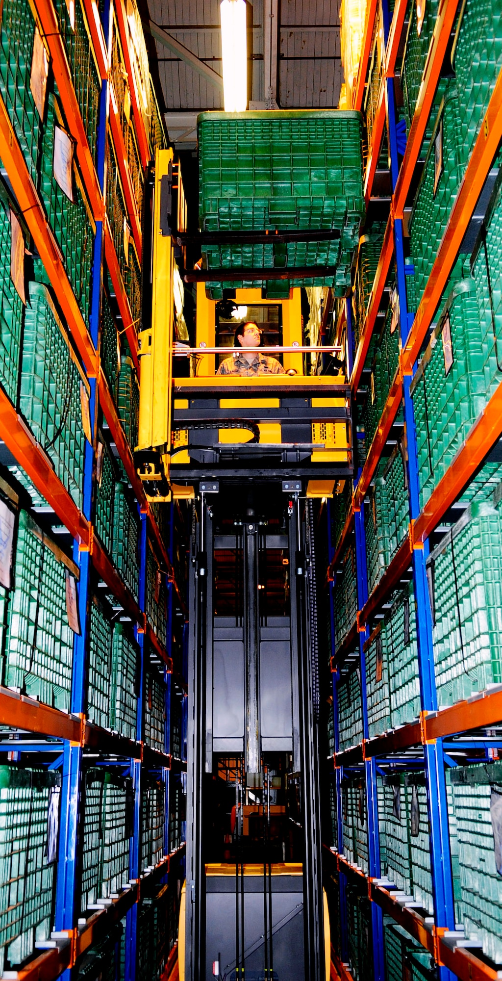 RAF MILDENHALL, England -- Airman 1st Class Steven Lauzon, 100th Logistics Readiness Squadron individual protective equipment worker, uses material-handling equipment to store a bin filled with chemical warfare defense equipment here Feb. 4, 2011. The equipment is stored on a shelf in a bin row until it is needed for deployers. (U.S. Air Force photo/Senior Airman Ethan Morgan)
