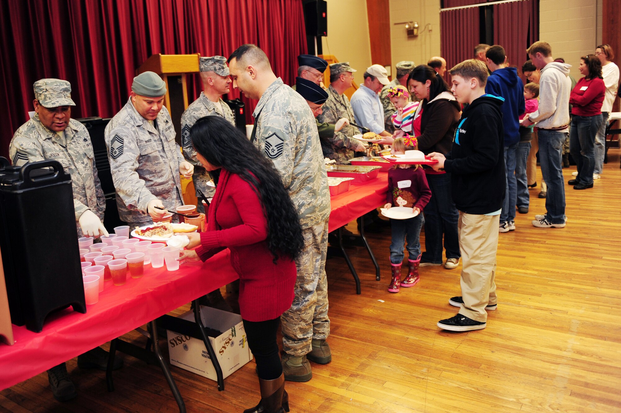 Team Little Rock leaders serve food to deployed Airmen’s families during the deployed spouses’ dinner Feb. 1, 2011, at Little Rock Air Force Base, Ark. The deployed spouses’ dinner is a way for Team Little Rock to support deployed members’ spouses by offering them a break from the kitchen and showing appreciation for their support to the mission. (Photo by U.S. Air Force Senior Airman Jim Araos)