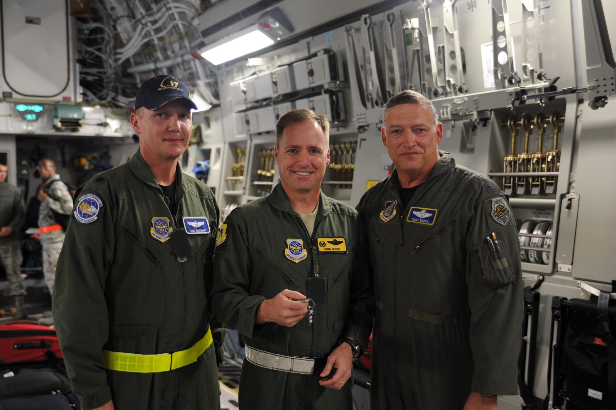 Lt. Col. Todd Grooms, 17th Airlift Squadron director of operations, Col.
John Wood, 437th Airlift Wing commander and Gen. Gary North, commander of
Pacific Air Forces, Air Component Commander for U.S. Pacific Command and
Executive Director, Pacific Air Combat Operations Staff at Joint Base Pearl
Harbor-Hickam, Hawaii, pose for the camera after presentation of the
ceremonial keys to Joint Base Charleston's newest aircraft. (U.S. Air Force Photo illustration by
Tech. Sgt. Chrissy Best)
