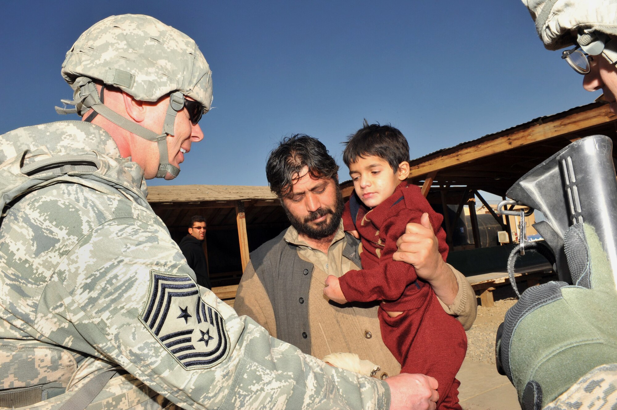 Chief Master Sgt. Craig Adams, 455th Air Expeditionary Wing command chief, interacts with the Afghan local during his visit at the Egyptian Hospital at Bagram Airfield, Afghanistan, Jan. 17, 2011. (Air Force photo by Senior Airman Sheila deVera) 