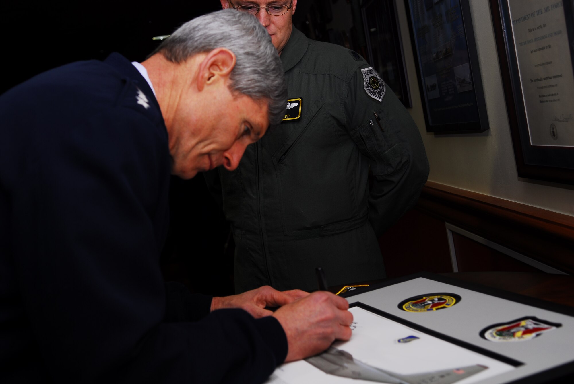 YOKOTA AIR BASE, Japan -- Air Force Chief of Staff Gen. Norton Schwartz signs a lithograph for the 36th Airlift Squadron during a visit Feb. 8, to Yokota. General Schwartz visited Airmen to discuss issues affecting the Air Force in 2011. (U.S. Air Force photo/Airman 1st Class Lynsie Nichols) 
