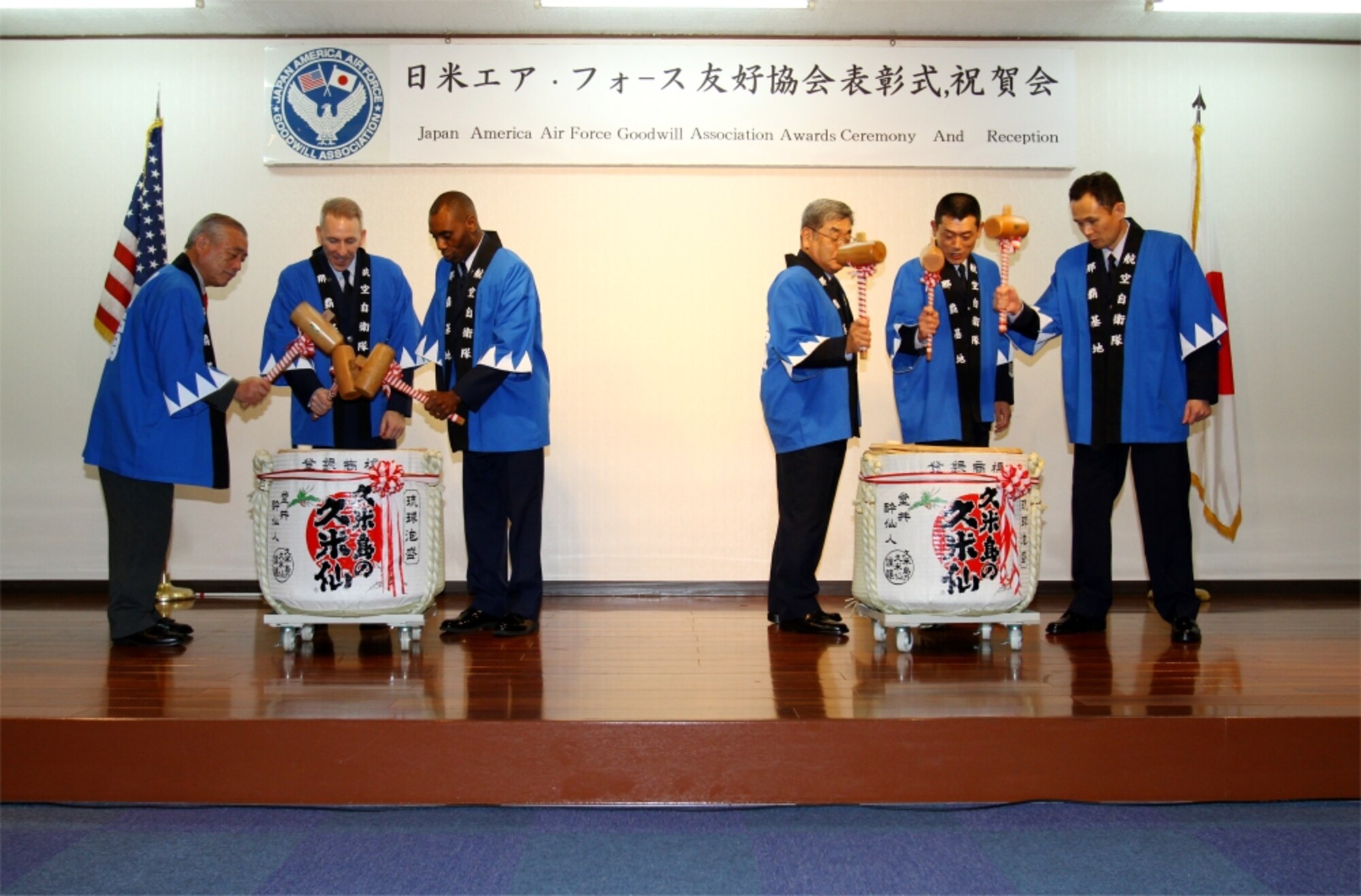 Ceremony participants use wooden hammers to break Japanese sake barrels' tops to commemorate the ceremonious day, Feb. 4. The ceremony and reception recognized Master Sgt. Jerry Laney and Japan Air Self Defense Force Master Sgt. Hiromasa Namiki for working to strengthen the bonds between the U.S. and Japan. (photo by JASDF Master Sgt. Tatsuya Hosobuchi)