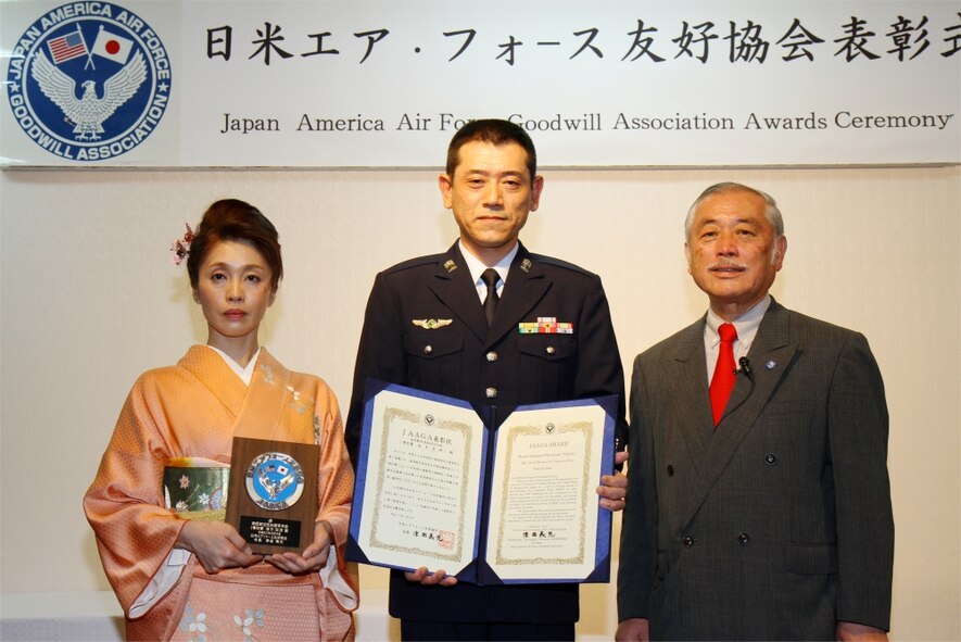 (From right to left) Japan Air Self Defense Force Gen. (retired) Yoshimitsu Tsumagari, Master Sgt. Hiromasa Namiki and Mutsuyo Namiki pose for an award photo during the 13th annual Japan-America Air Force Goodwill Association award ceremony at Naha Air Base, Feb. 4. During the ceremony and reception, one Air Force non-commissioned officer and one Japan Air Self Defense Force NCO were presented awards for working to strengthen the bonds between the U.S. and Japan. (photo by JASDF Master Sgt. Tatsuya Hosobuchi)