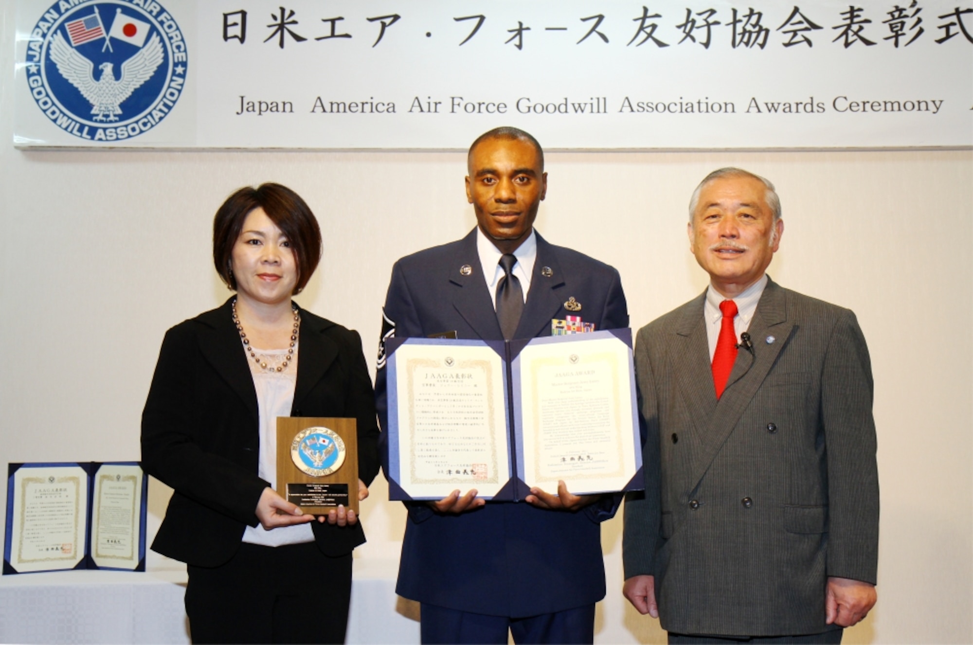 (From right to left) Japan Air Self Defense Force Gen (RET) Yoshimitsu Tsumagari, Master Sgt. Jerry Laney and Mrs. Yuko Laney pose for an award photo during the 13th annual Japan-America Air Force Goodwill Association award ceremony at Naha Air Base, Feb. 4. During the ceremony and reception, one Air Force non-commissioned officer and one JASDF NCO were presented awards for working to strengthen the bonds between the US and Japan. (photo by JASDF Master Sgt. Tatsuya Hosobuchi)