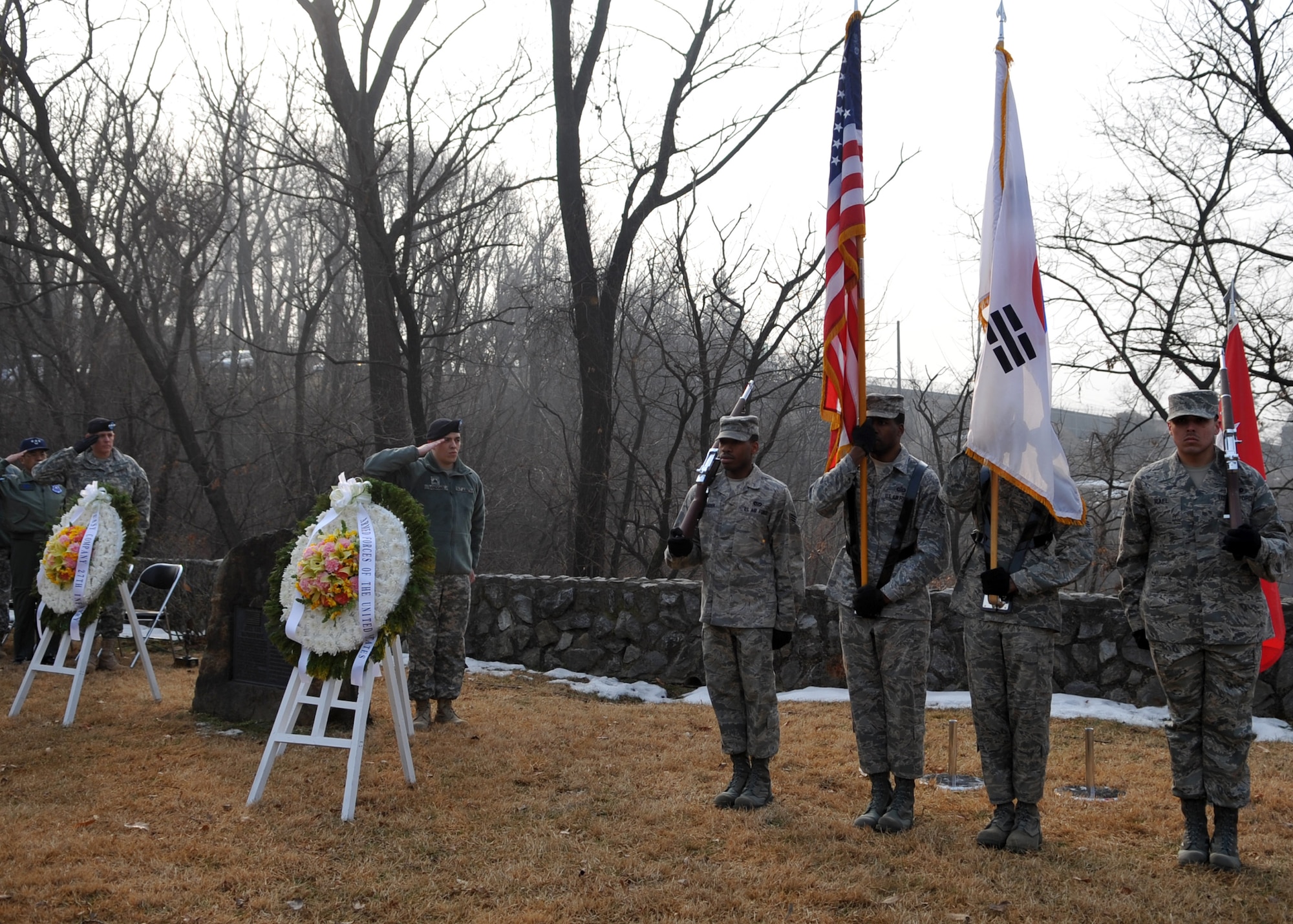 The base Honor Guard posts colors during the 60th Anniversary "Battle of Hill 180” ceremony Feb. 8 at Osan Air Base, Republic of Korea. The ceremony paid tribute to the actions of the Soldiers of the 27th Infantry Regiment "Wolfhounds" during a bayonet charge up Hill 180 here Feb. 7, 1951. (U.S. Air Force photo/Senior Airman Evelyn Chavez)