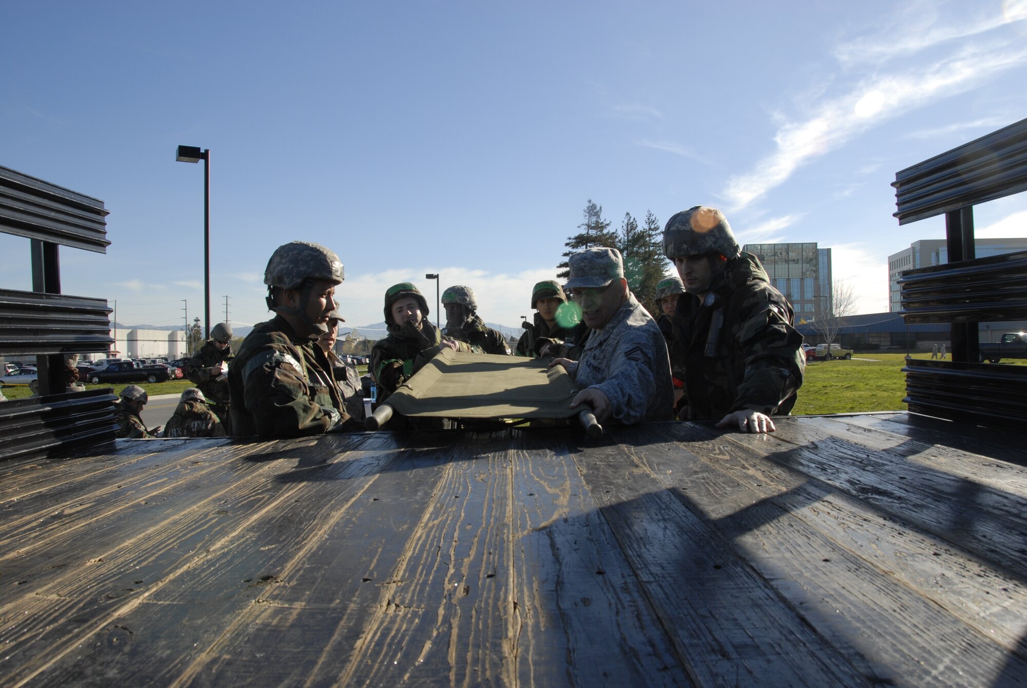 Airmen from the 129th Rescue Wing dressed in Mission Oriented Protective Posture level suits receive instruction on proper litter transport procedures during war skills training at Moffett Federal Airfield, Calif., Feb. 5, 2011. The 129th Rescue Wing is preparing for an upcoming Operation Readiness Inspection in December 2011. (Air National Guard photo by Tech. Sgt. Ray Aquino/RELEASED)
